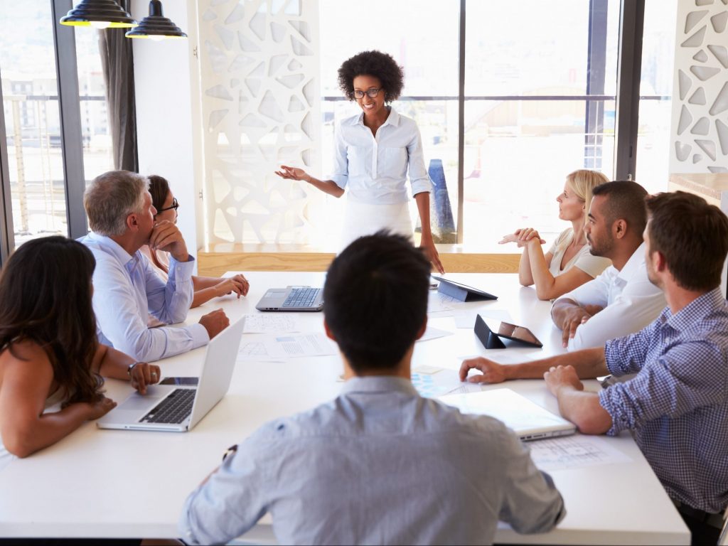 Consultant presenting ideas to a group of colleagues
