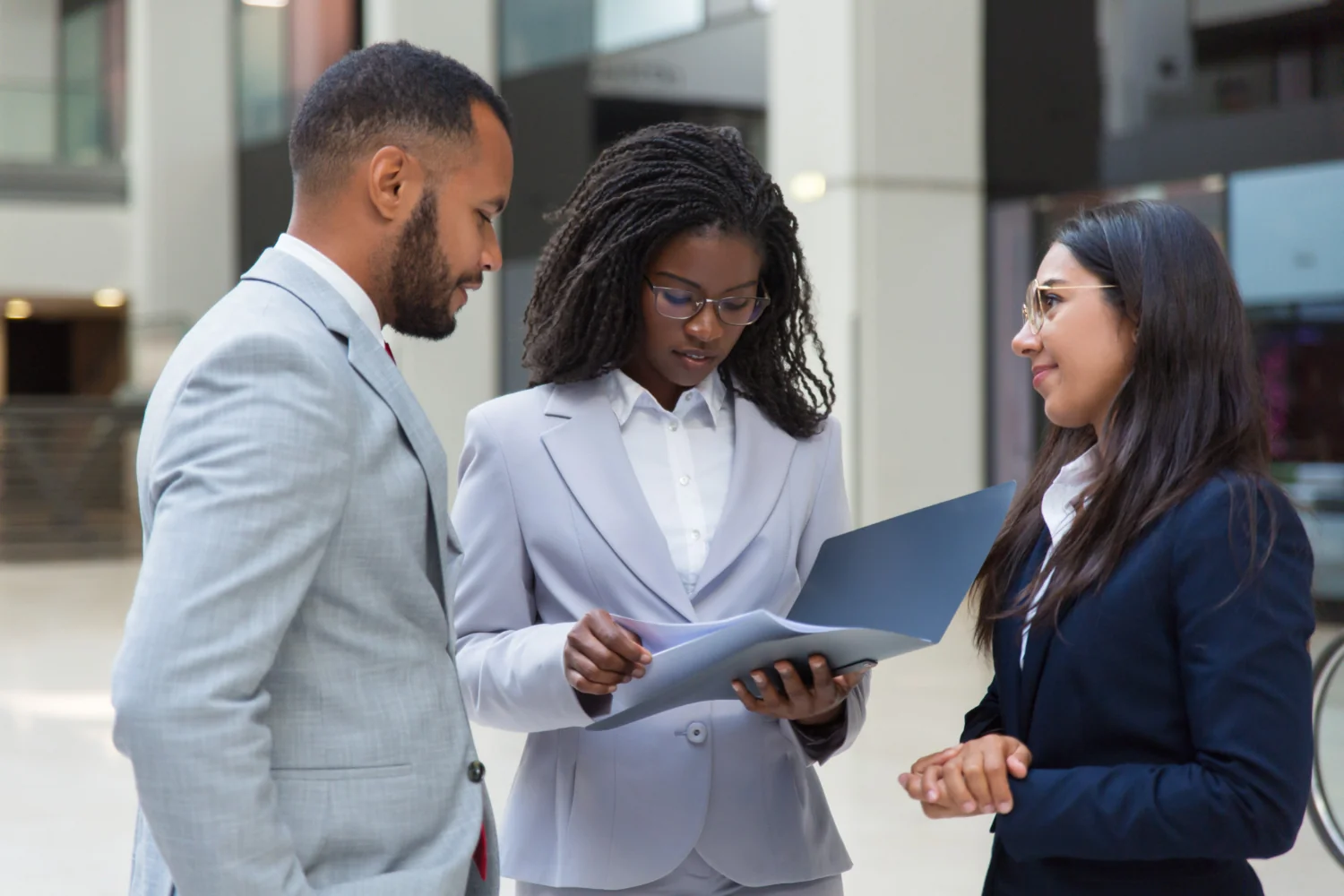 Financial advisers discussing documents with a client